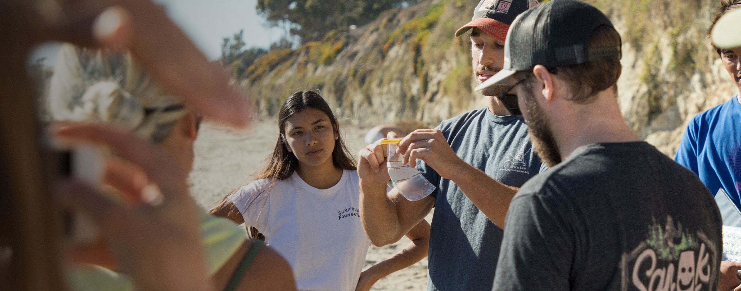 A group of volunteers looking at a water sample